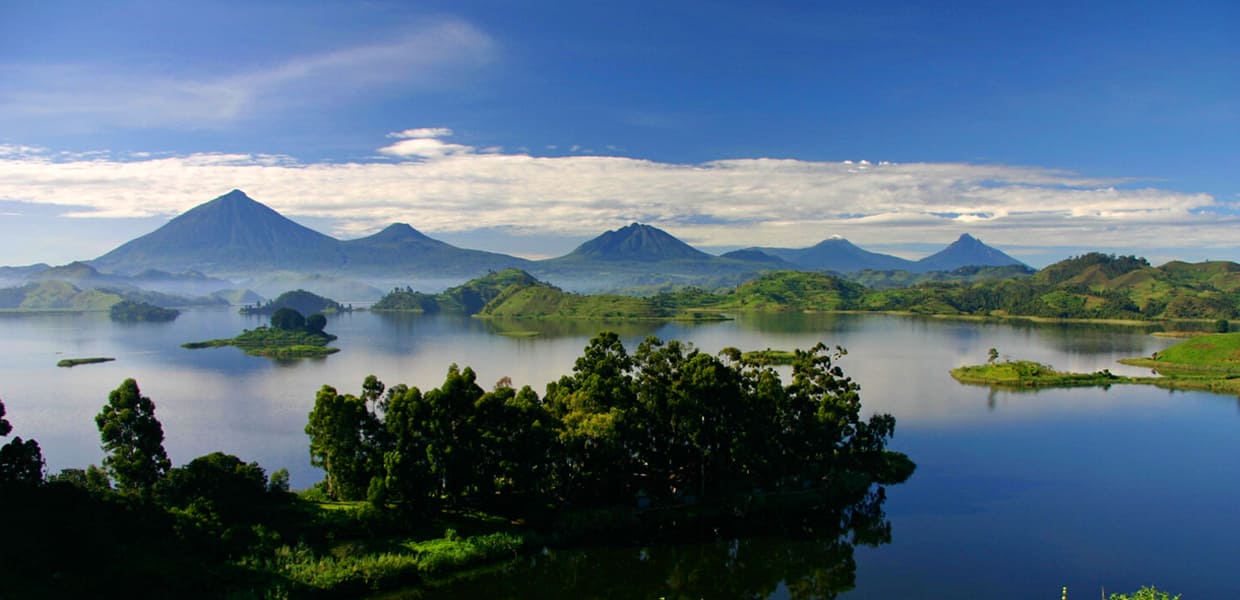 A distant view of volcano mountain ranges; Mt. Muhavura, Mt. Gahinga and Mt. Sabinyo